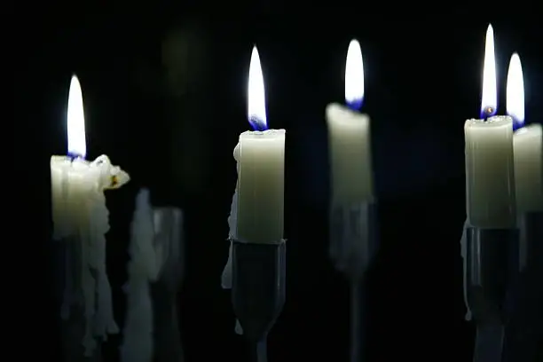 candles in the dark with melting wax
