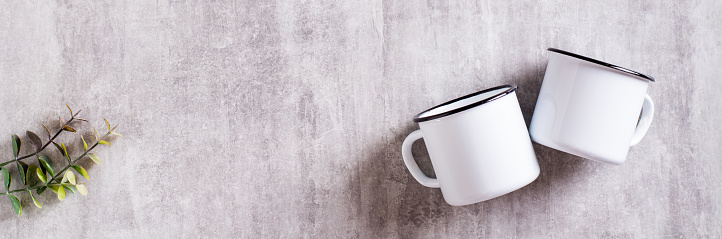 White empty metal mug on gray background for web banner. Top view
