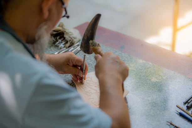 indonesian man spinning clay on a wheel in pottery workshop
