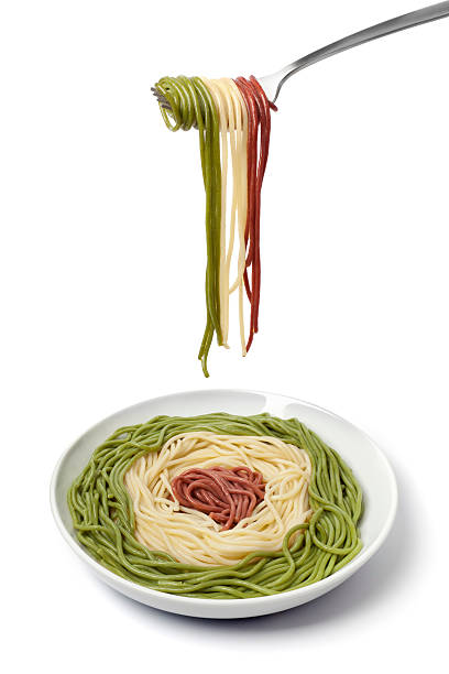 Dish and fork with cooked Spaghetti tricolore
