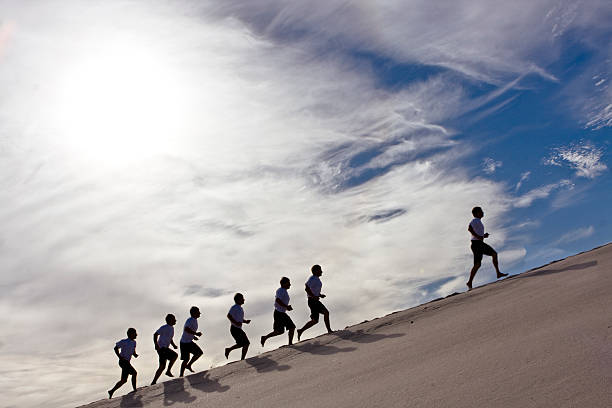 race mutiple shot of same person running in sand following stock pictures, royalty-free photos & images