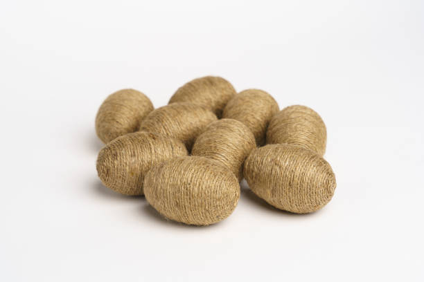 istock Hand wrapped easter eggs with jute twine, isolated white background. 1473003961