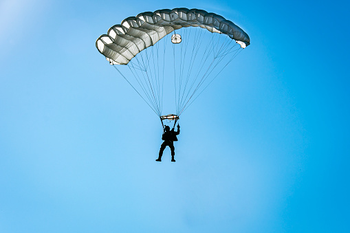 Silhouette, parachutist, descending, white parachute