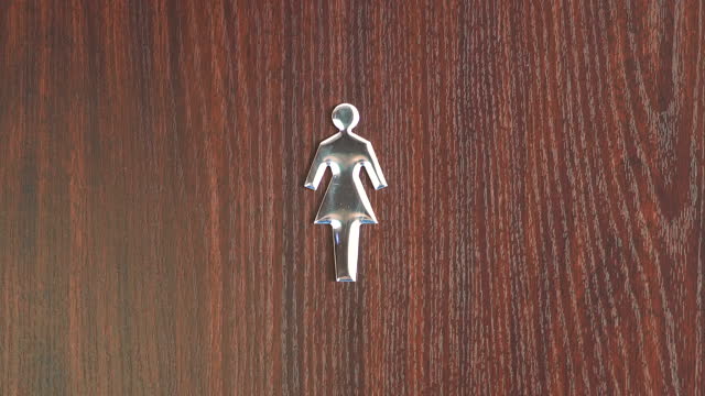Women's Restroom Sign on a Door in 4k slow motion 60fps