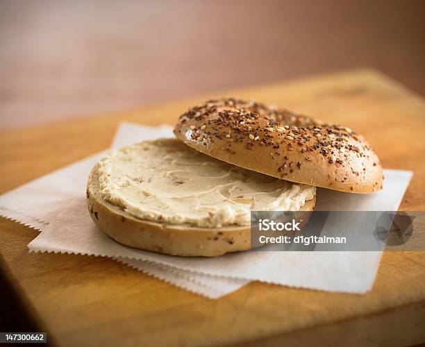 Bagel With Cream Cheese On Cutting Board Stock Photo - Download Image Now - Bagel, Bread, Breakfast