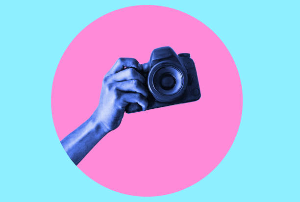 istock Modern Design. Modern art collage with an image of a man's hand holding a camera, taking a picture. 1473009882
