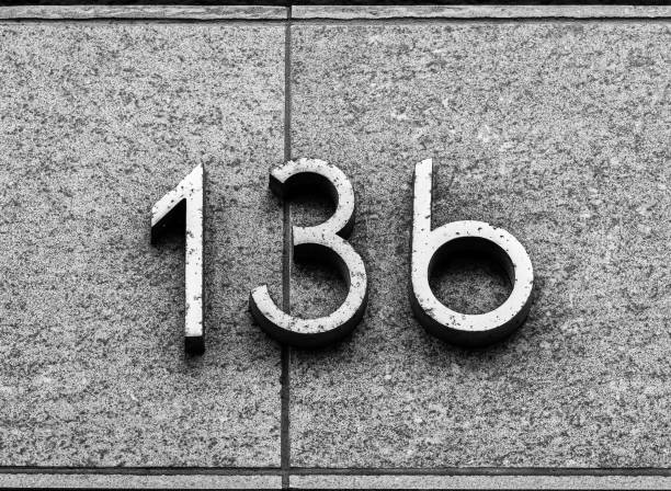 istock Metal house number on stone wall 1473010962