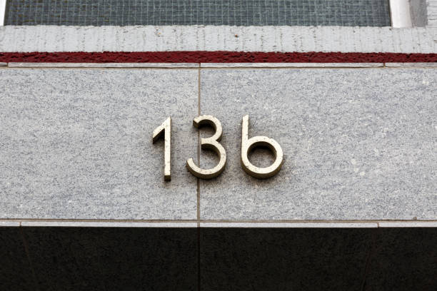 istock Metal house number on stone wall 1473010999