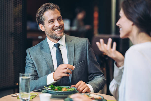 istock Couple of entrepreneurs having dinner and talking 1473011470