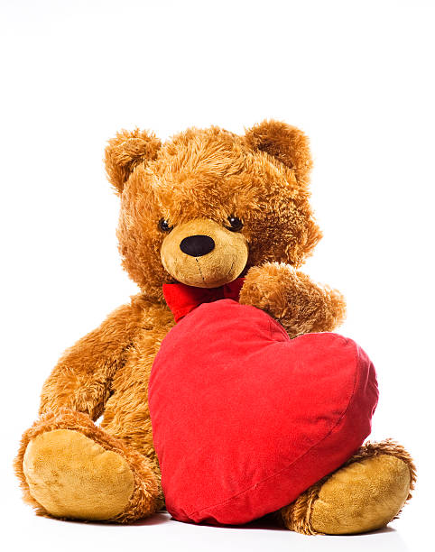 istock Brown bear holding a red soft heart 147301240