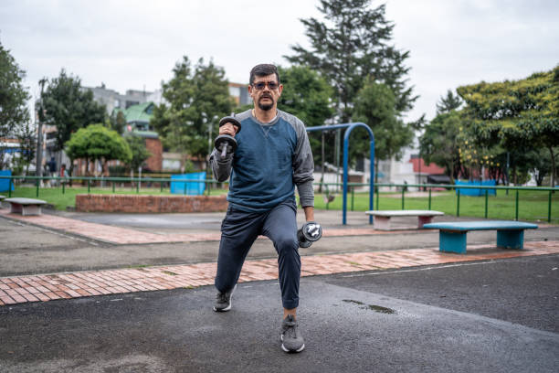 istock Mature man training with dumbbell outdoors 1473013913