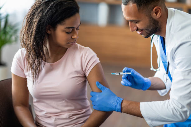 istock Black lady getting vaccinated against coronavirus at clinic 1473015824