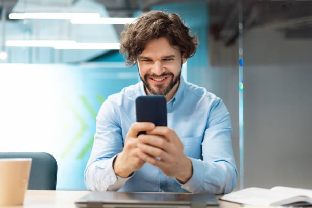 istock Portrait of businessman using smartphone at office 1473016484