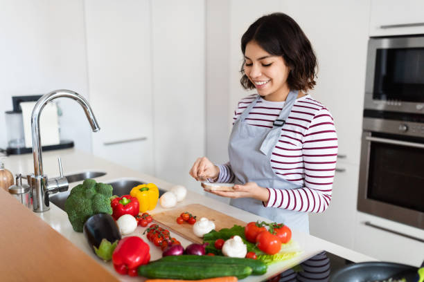istock Positive arab lady making sandwich at modern kitchen 1473017283