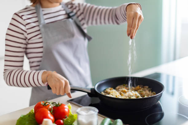 istock Unrecognizable female chef preparing food at home 1473017420