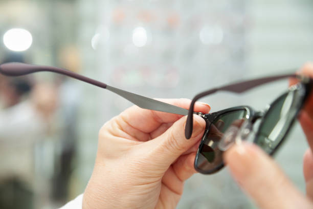 istock Holding glasses in an optician 1473017504