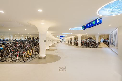 Amsterdam, The Netherlands - March 12, 2023: Modern Bicycle Parking Station called Stationsplein is built under the water near Amsterdam Central Station, opened in February 2023 and has room for 7,000 bicycles.