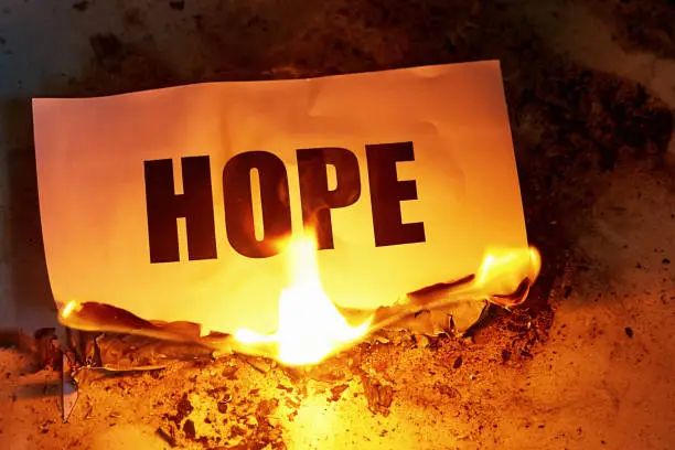 Photo of Hope is destroyed: the word goes up in flames, representing despair
