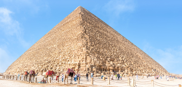 Pyramids of Giza, Giza Necropolis, Egypt - March 12, 2023: The Giza Necropolis is a large area near Giza, a suburb of Cairo that has many tombs and burial sites. It is also where you can find the famous Pyramids of Giza, the Great Sphinx, and more. The name comes from the ancient Greek word nekropolis, which literally means “city of the dead”.\n\nThe Giza Complex was once near the ancient Egyptian capital of Memphis, and the Giza plateau is where a number of pharaohs, queens, and nobles of the Fourth Dynasty of ancient Egypt were buried. \n\nAll three of Giza's pyramids and their elaborate burial complexes were built  from roughly 2550 to 2490 B.C. The pyramids were built by Pharaohs Khufu, Khafre, and Menkaure.