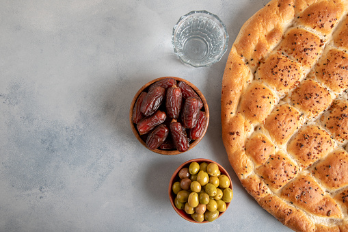 Ramadan pita, dates fruit and green olives.Islamic iftar table