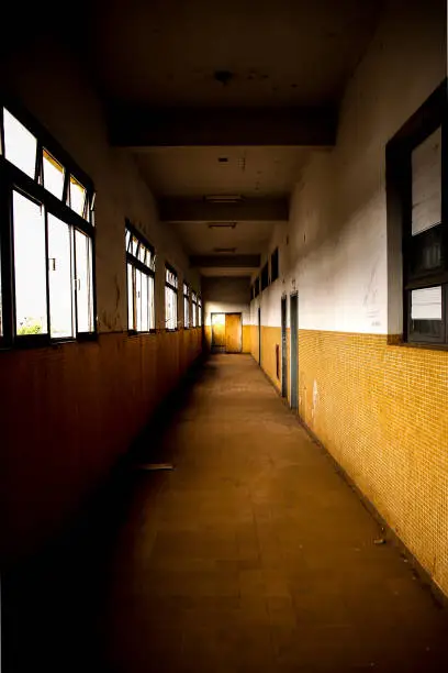 Photo of Old dark hallway with yellow tiles