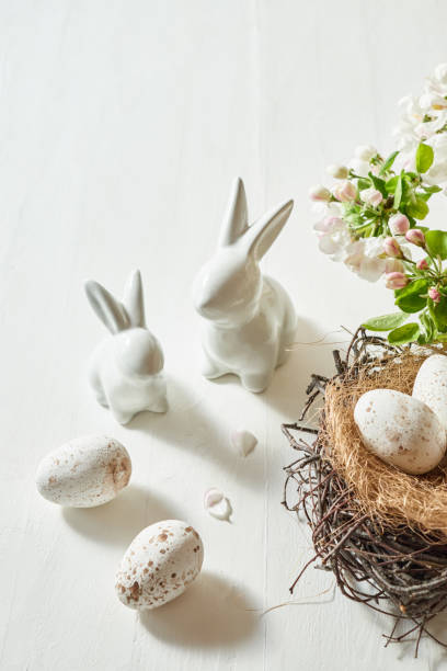 istock Holiday composition with spring flowers and easter eggs, white bunny on a light background. Happy easter concept with copy space 1473023446