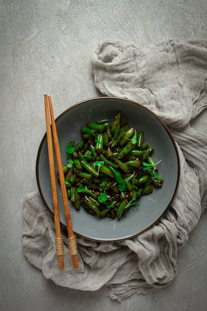 fried bean pods, in soy sauce, with sesame seeds, homemade, no people,
