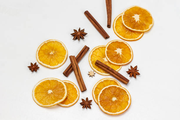 istock Cinnamon sticks, star anise and orange chips on white 1473025163