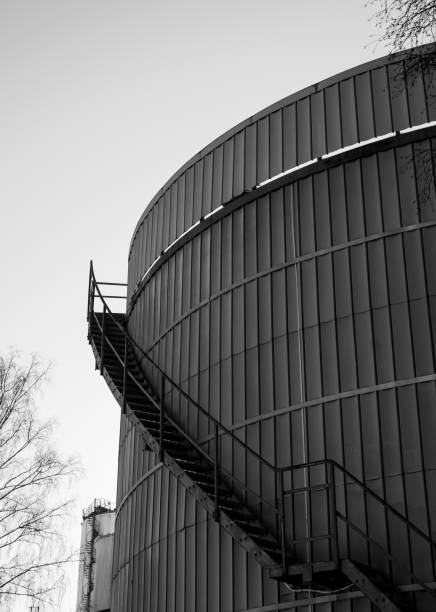 Low angle view of gas holder against clear sky