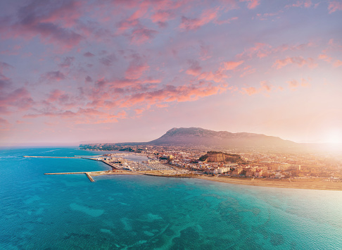 Denia aerial skyline in Mediterranean Alicante of Spain Drone point of view Costa Blanca with Montgo mountain background at sunset