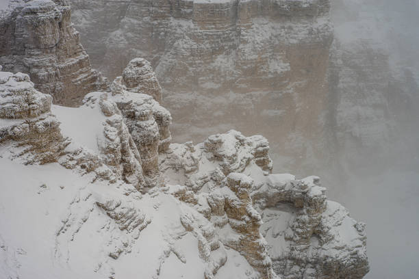 photo of dolomite rock in winter with snow and fog