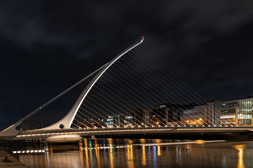 The Samuel Beckett Bridge over the River Liffey illuminated at night  (Looking upstream from the south bank), Dublin, Ireland