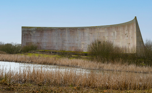 A relic of world war one,  the sound mirrors were primitive listening devices that were the predecessor of Radar .   They have stood for over 100 years in Dungeness, Kent