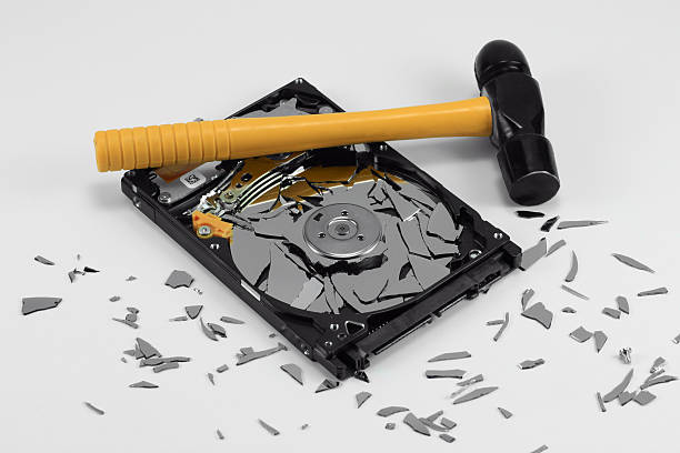 Broken Hard Disk Drive and Hammer stock photo