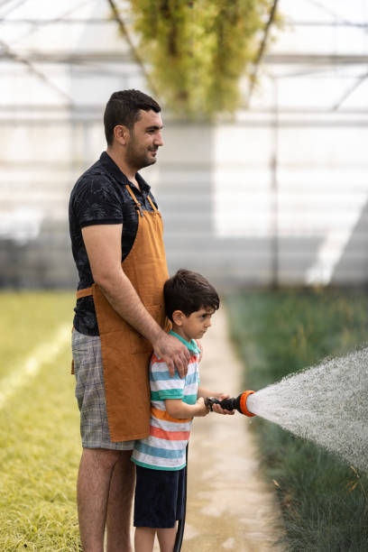 istock Father and boy working greenhouse 1473032325