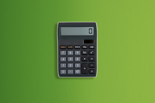 Close up view from above Calculator on green background with copy space for counting and planning