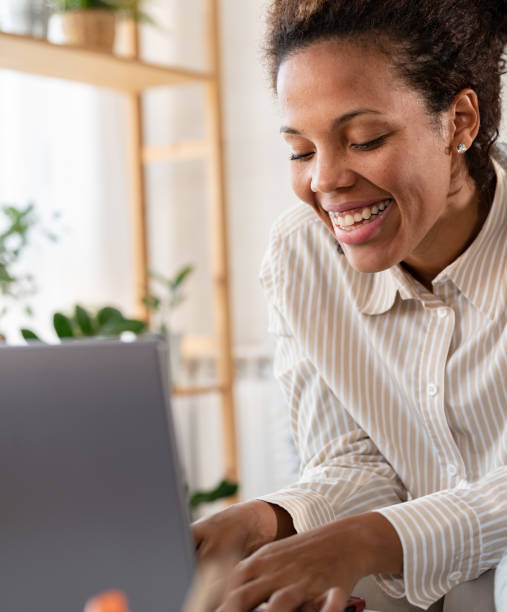 istock Young African ethnicity businesswoman working from home using a laptop computer 1473033389