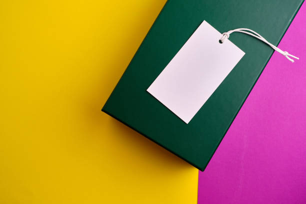 istock Empty tags eco white matte labels on a yellow-pink background. Eco friendly label concept. Layout. Space for text. Mockup 1473033724