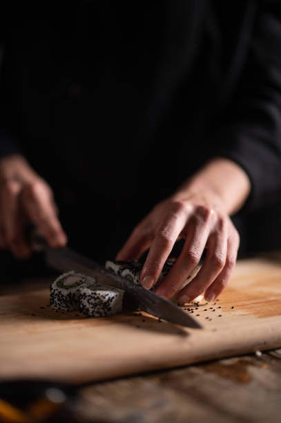 istock Female sushi chef making roll sushi 1473033854