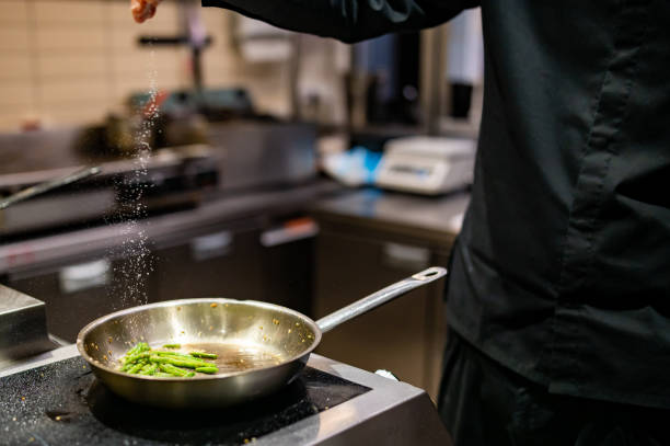 istock man chef cooking fried green bean in frying pan on restaurant kitchen 1473034694
