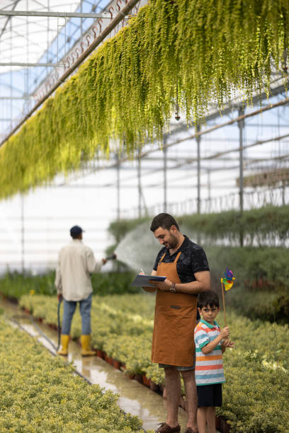 istock Father and boy working greenhouse 1473034761