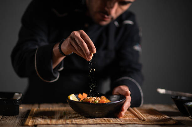 Male chef preparing a bowl of noodle