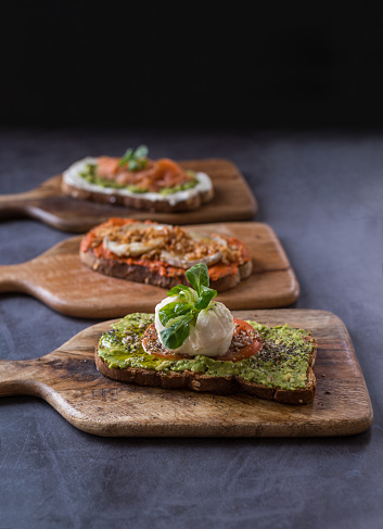 Vertical studio photo with focus on a variety of healthy toast ready to eat