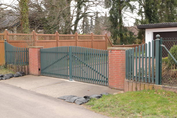istock a driveway with a green sliding gate 1473036354