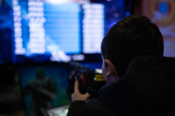 istock rear low light view of kid playing in a virtual game machine. 1473037365