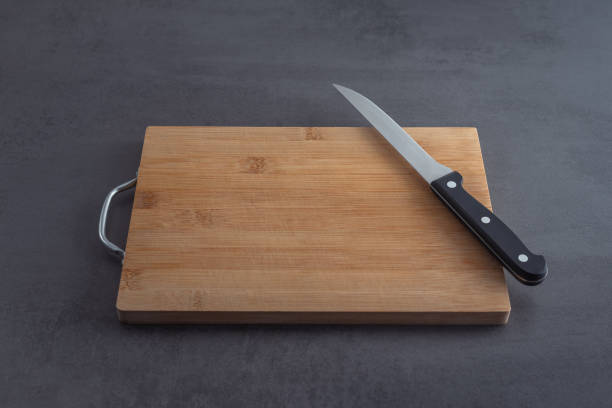 istock Cutting board and knife on a grey kitchen countertop 1473039065