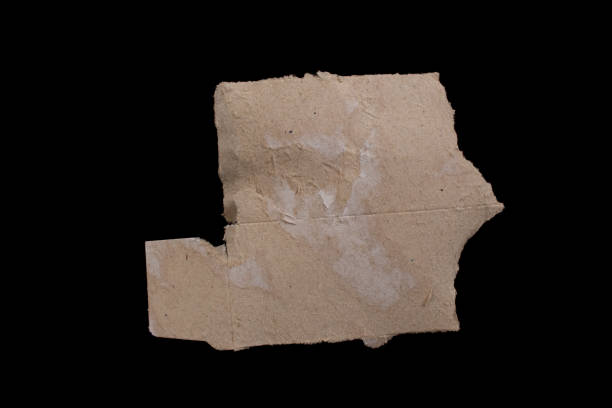 istock Ripped cardboard paper isolated on a black background 1473039255