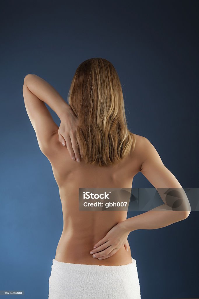 Woman massaging pain back Woman massaging pain back  Women Stock Photo