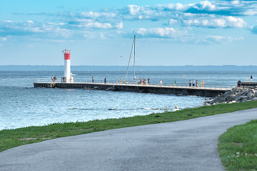 Oakville, Ontario. 07/21/2021. View from Lakeside Park of a lighthouse at the end of a jetty.