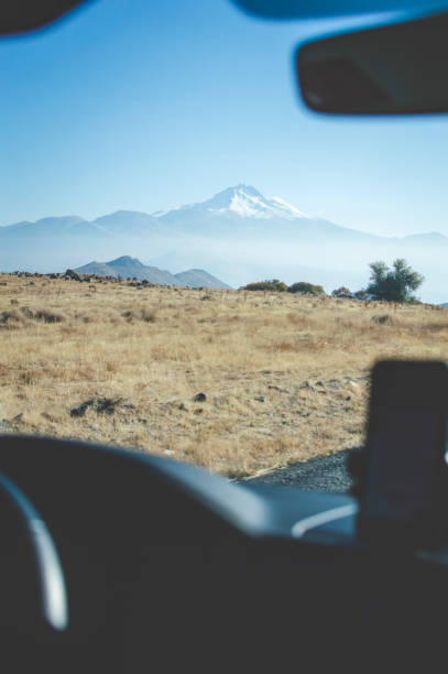 istock View through vehicle window to snowcapped mountain 1473043166